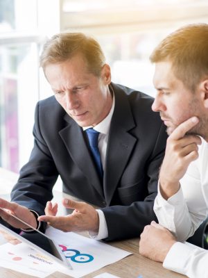 two-businessman-discussing-business-plan-digital-tablet
